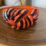 Orange and navy blue knotted sequin